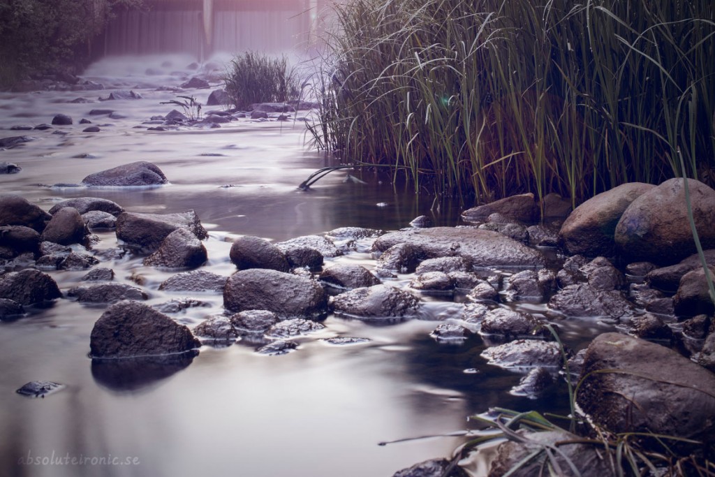 Rocks in the river by the waterfall